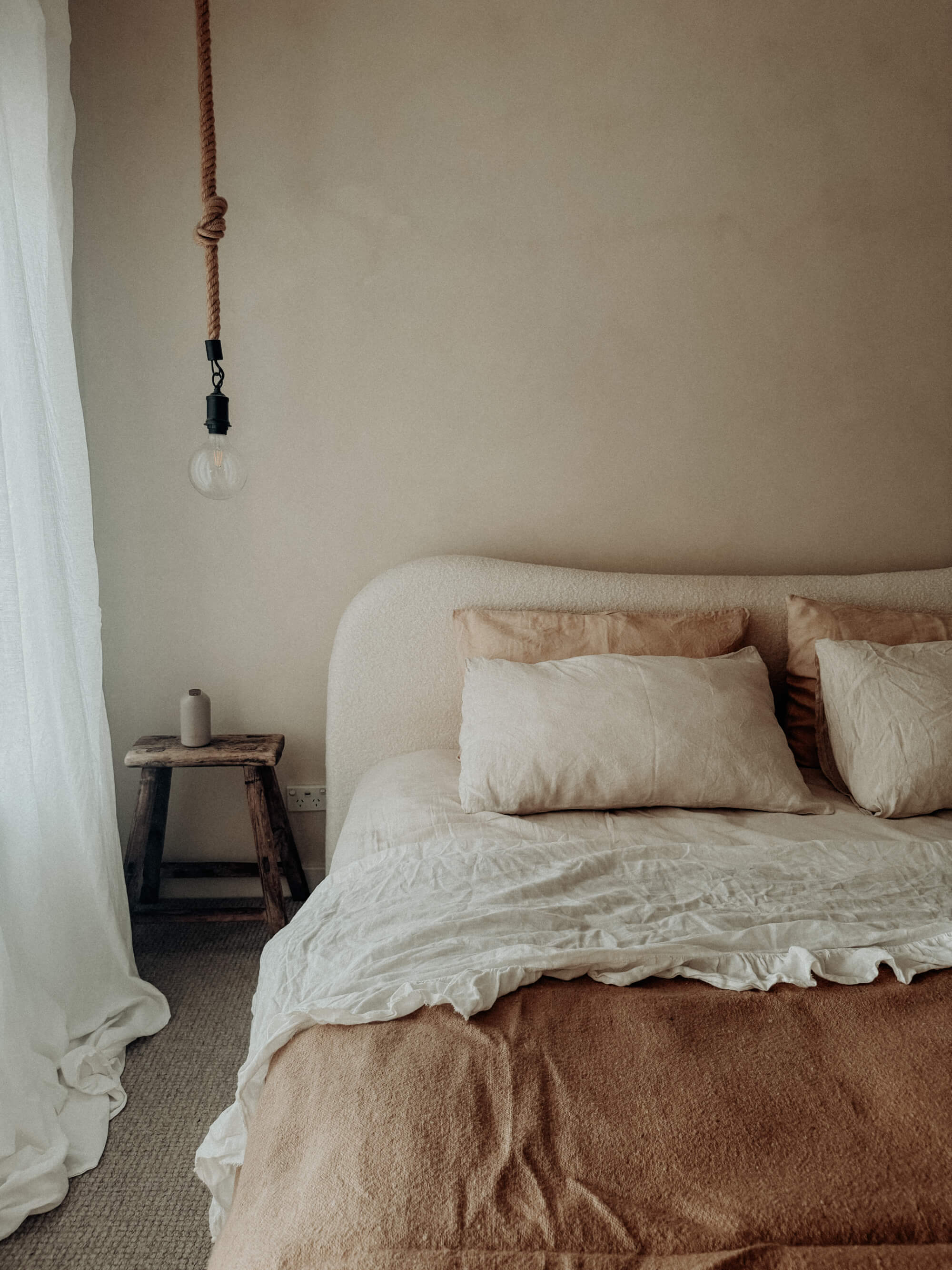 A boho bedroom with natural limewash paint