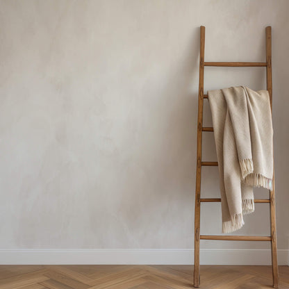 Bright airy neutral limewash with ladder and blanket