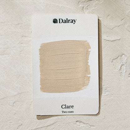 A Dalray paint swatch card labeled 'Clare Two coats' showing an earthy beige painted limewash swatch on a textured off-white background.
