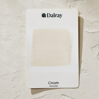 A Dalray paint swatch card showing a textured cream limewash color sample labeled 'Cream Two Coats' on a light textured background.